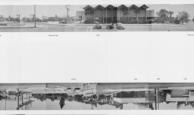 A page from a book featuring two black-and-white strips of photos, one at top and one upside down on the bottom, showing buildings on both sides of the same street.