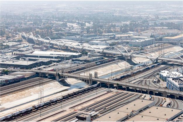 A color photograph features an aerial view of several concrete viaducts and two bridges that cross over them.