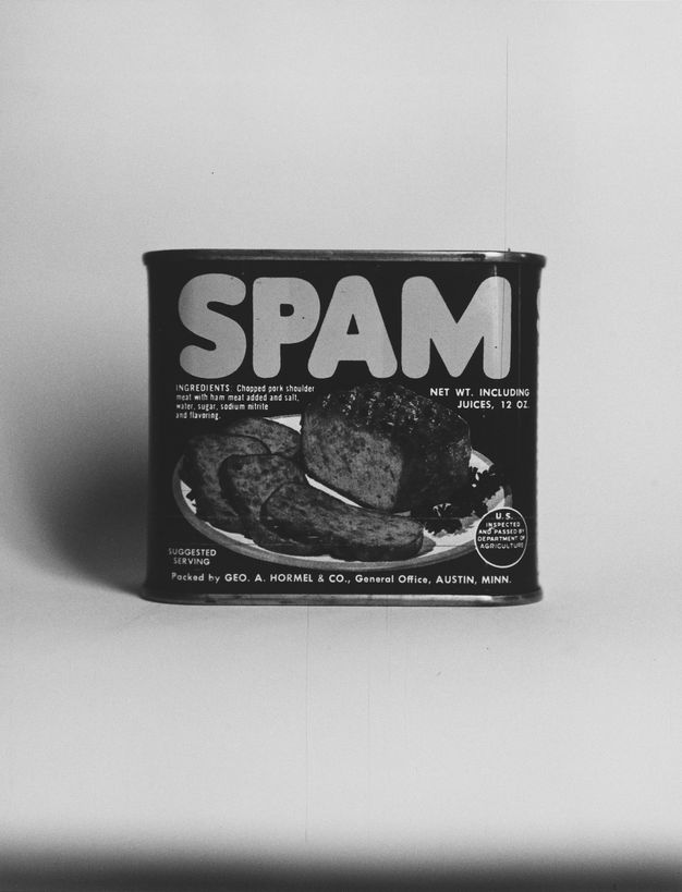 A black-and-white photo of a can of Spam on a white background.