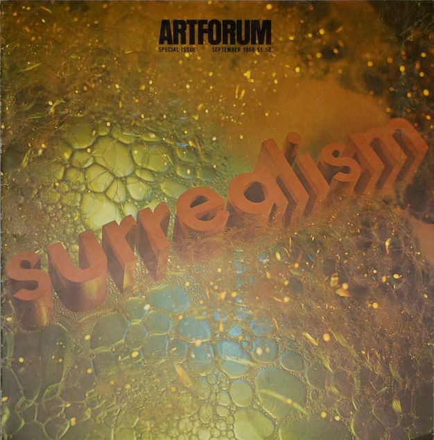 A magazine cover features an upclose photo of a gold, mirrored surface speckled with soap bubbles. The word “surrealism” is rendered diagonally in dimensional, orange block letters across the cover.