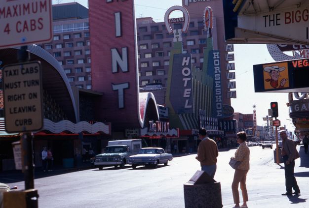 A color photo features people and cars crowding the Las Vegas strips during the day.