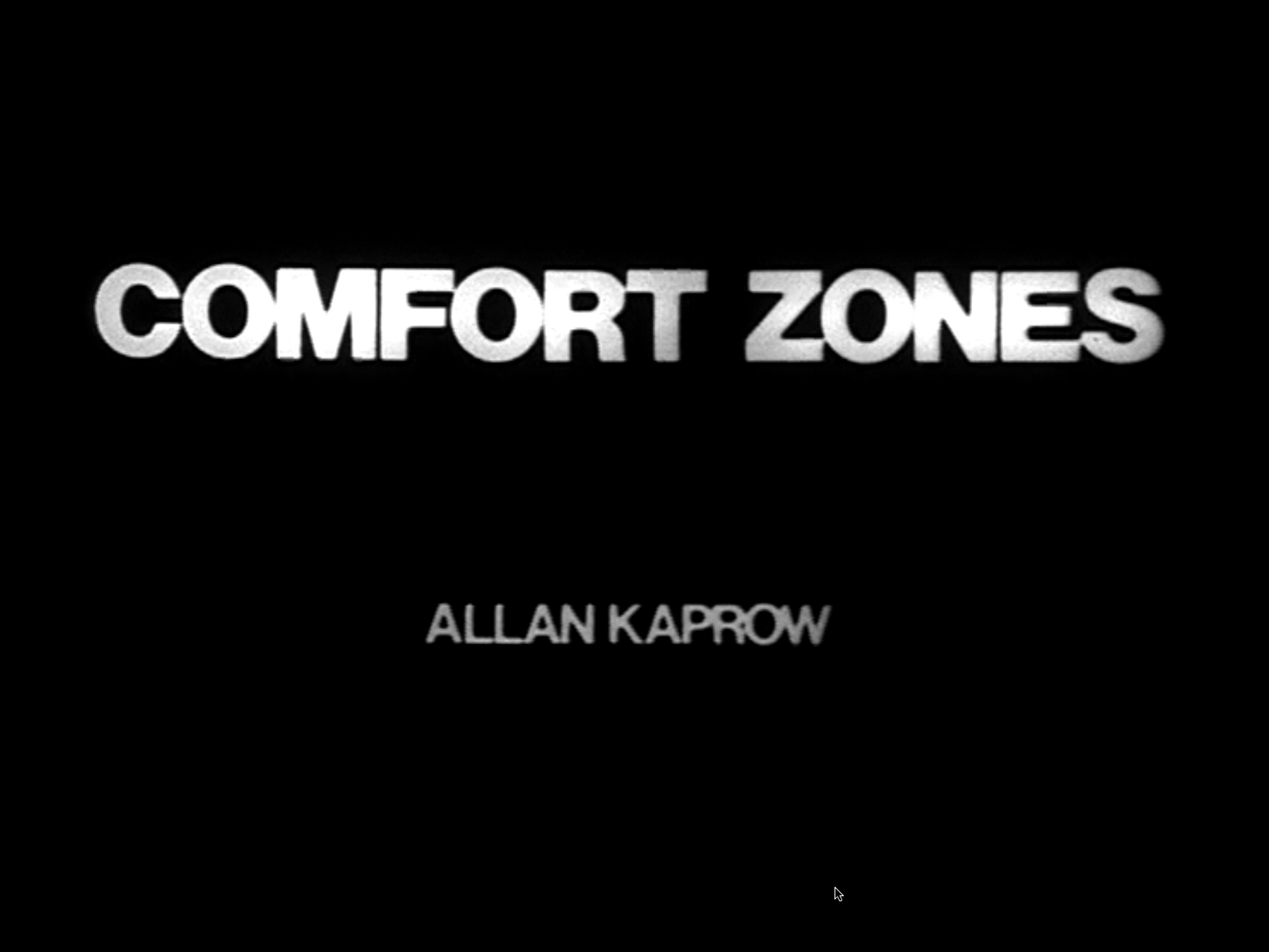 Black and white film opening with male voiceover followed by title card reading, Comfort Zones Alan Kaprow in white on black background. The film alternates between title cards with three to five short sentences read aloud by male voiceover and video of one or two people performing the actions from the previous title card.&nbsp;Shots are stable and either close-ups focusing on hands or faces, or wide shots of chest-up or full-body figures. Close-ups often capture movement or speech. Figures or hands are typically at the center of the frame, with no other points of visual interest. First half of video takes place indoors, and the second, outdoors.&nbsp;Four by three aspect ratio.