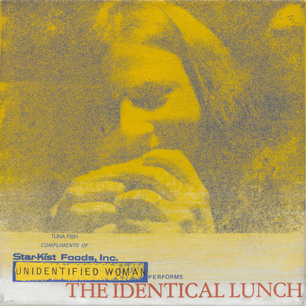 Square-shaped canvas with yellow and black photo print close up on top three quarters of a woman’s face while she eats a sandwich held to her mouth in both hands. Bottom quarter contains blue text “Tuna Fish Compliments of” and “Star-Kist Foods, Inc.” the latter appearing like the official logo. “Unidentified Woman performs The Identical Lunch” below in yellow, blue, and red.
