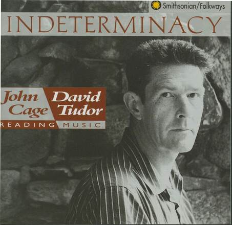 CD booklet cover containing allover black-and-white photograph of a man wearing a collared striped shirt looking to the camera. “INDETERMINANCY” in burgundy at top, and “John Cage David Tudor Reading Music” at left in a burgundy-and-white graphic to the left of the man’s head. 