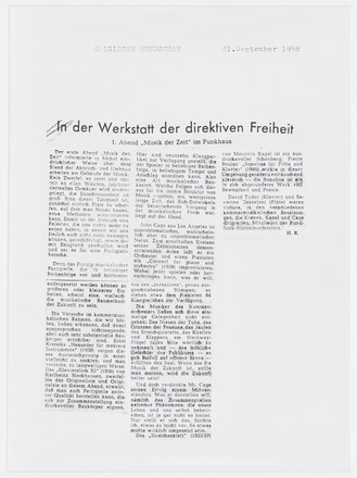 Photocopy of press clipping containing three columns of text in German on white page. Title “In der Werkstatt der direktiven Freiheit” across top of all three columns in bold font. Photocopy covers three quarters of the page.
