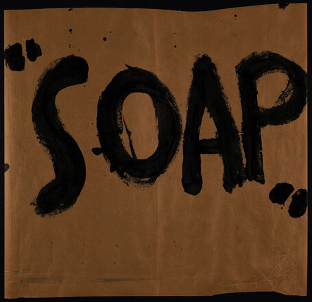 Large sheets of brown butcher paper covered with black painted text in English. “Soap” at center of first poster. Each subsequent poster contains time of day at top and sentences and/or phrases with actions to be performed below.