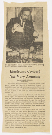 Vertical rectangular press clipping with black and white photo of man behind table of electronic devices and wires at top half and three paragraphs of text on bottom half. “Electronic Concert Not Very Amusing” at center in large italics. Caption below photo: “In Concert--Alvin Lucier of Braindeis’ Slosberg Music Center makes electronic music.”