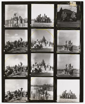 Contact sheet with twelve black and white photographs of over ten people in a field posing with metal barrels stacked two to three high.