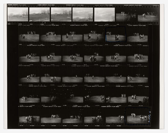 Photographic contact sheet with six lines of black and white photographs featuring spot lit groups of people in an otherwise empty room, most of whom appear in motion.