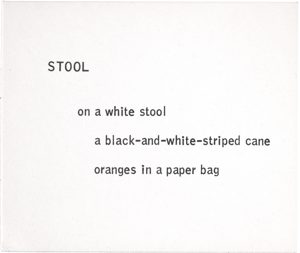 Stool: on a while stool a black-and-white-striped cane oranges in a paper bag