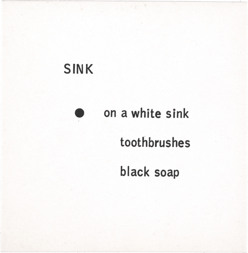 Sink: • on a white sink toothbrushes black soap