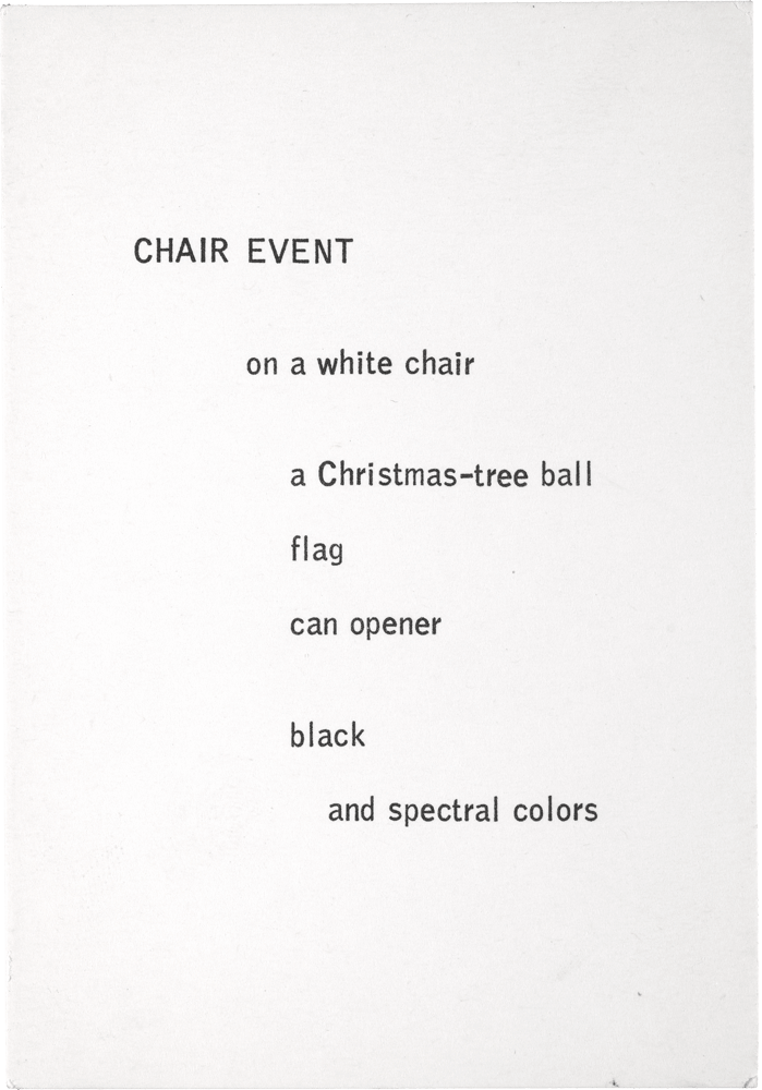 Chair Event: on a white chair a Christmas-tree ball flag can opener black and spectral colors
