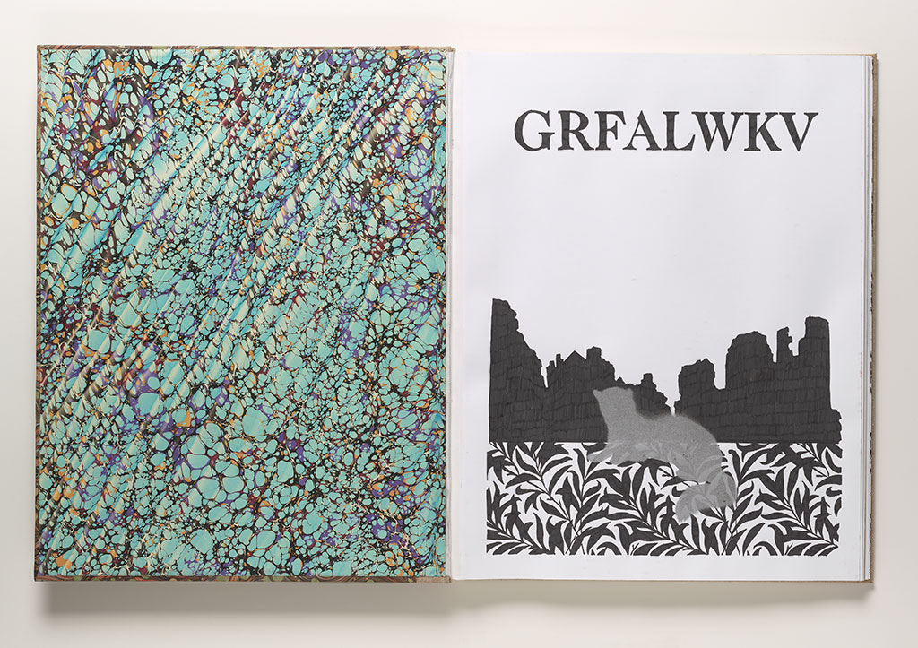 A unique book lies open to a spread featuring, on the left, turquoise, blue, and brown hand-marbled end paper. On the right is a drawing of a feline silhouette and backdrop beneath text in all capitals that reads G-R-F-A-L-W-K-V.
