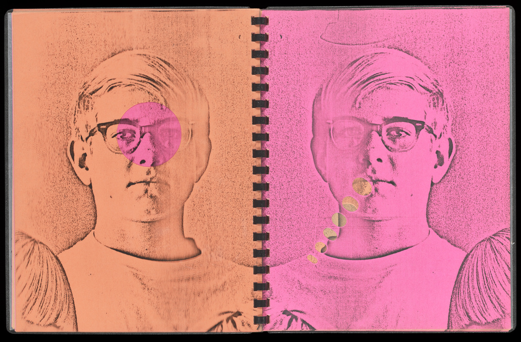 A spiral-bound book, the left page bright orange and the right fuschia, shows a photocopied Xerox image of a teenager in glasses looking at the viewer