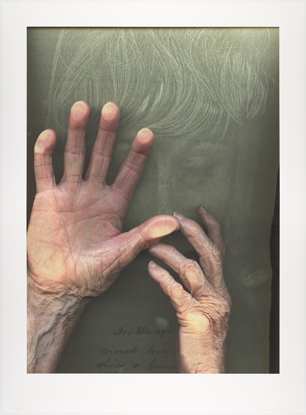 A color image shows two hands placed against the glass surface of a scanner, with a green Xerox print of a face in the background