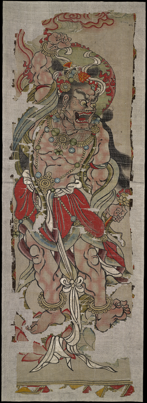 A wrathful, muscular form of the bodhisattva Vajrapaṇi, his mouth agape and a fierce look on his face, dominates this banner