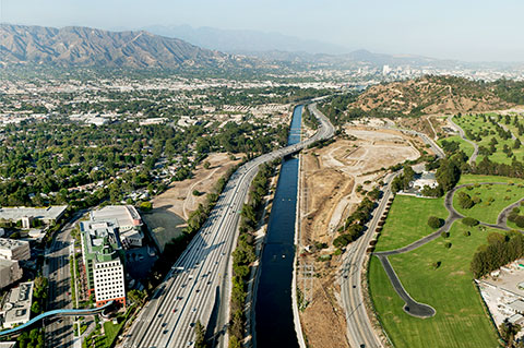 A color photograph shows an aerial view of the Los Angeles River flowing through the city.