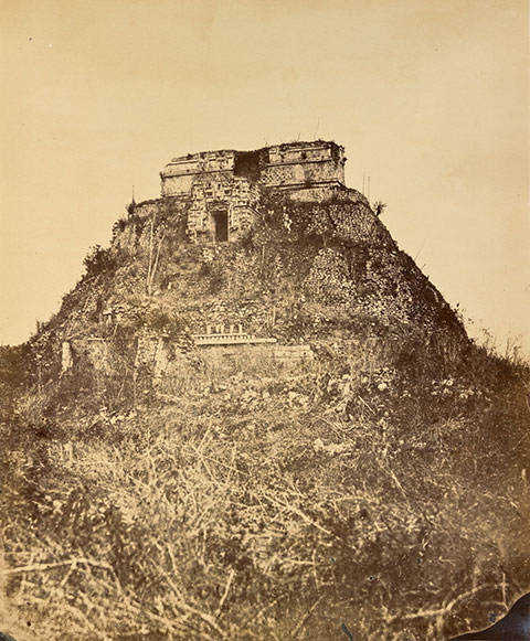 A black-and-white photograph of the ancient Pyramid of the Magician in Mexico. 