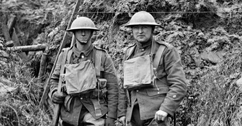 Black and white photo of two soldiers standing in trench